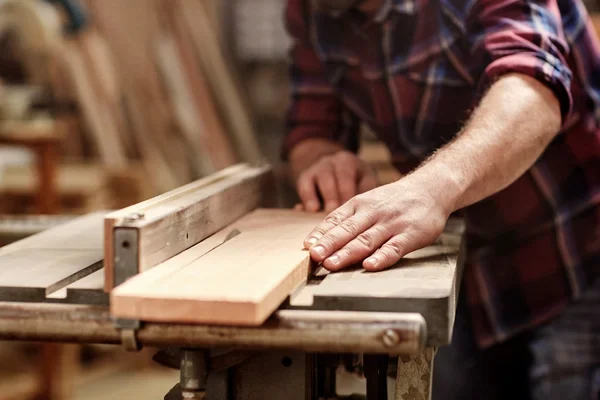 depositphotos_100906810-stock-photo-craftsman-cutting-plank-with-circular